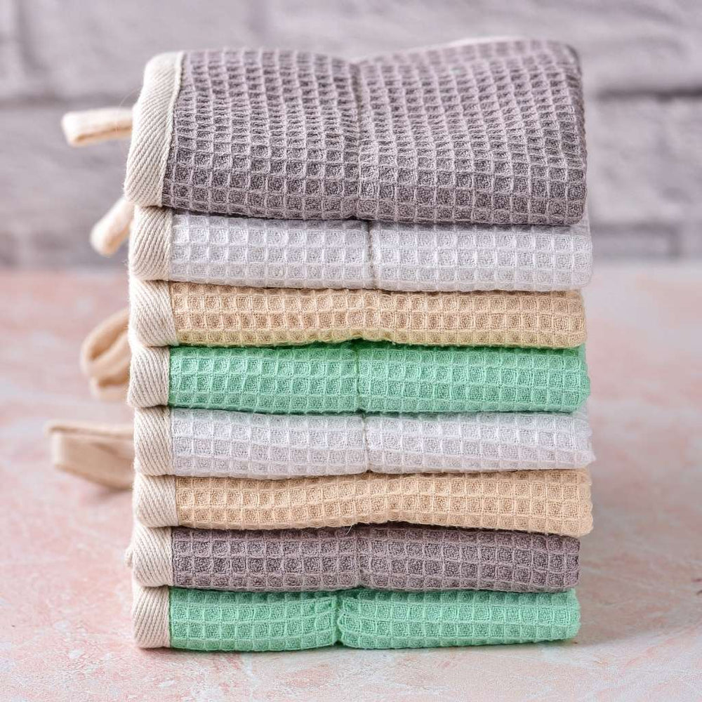 Stacked multi-colored cotton dish cloths.