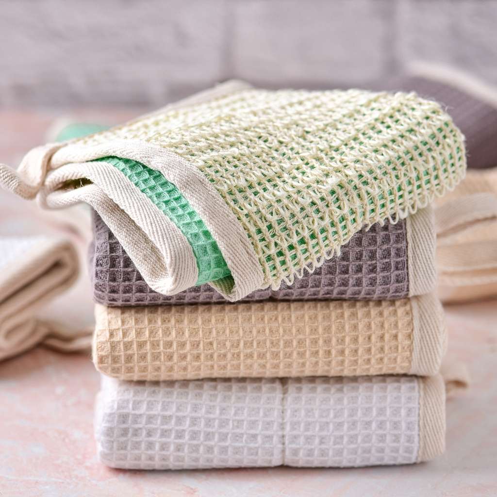 Stacked multi-colored cotton dish cloths showing scrubbing side.