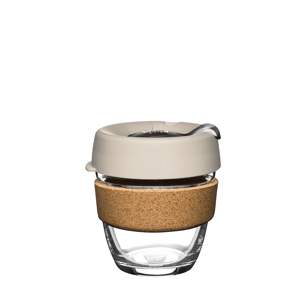 Small 8 ounce glass keep cup with white and gray lid and 100 percent recovered cork band. 