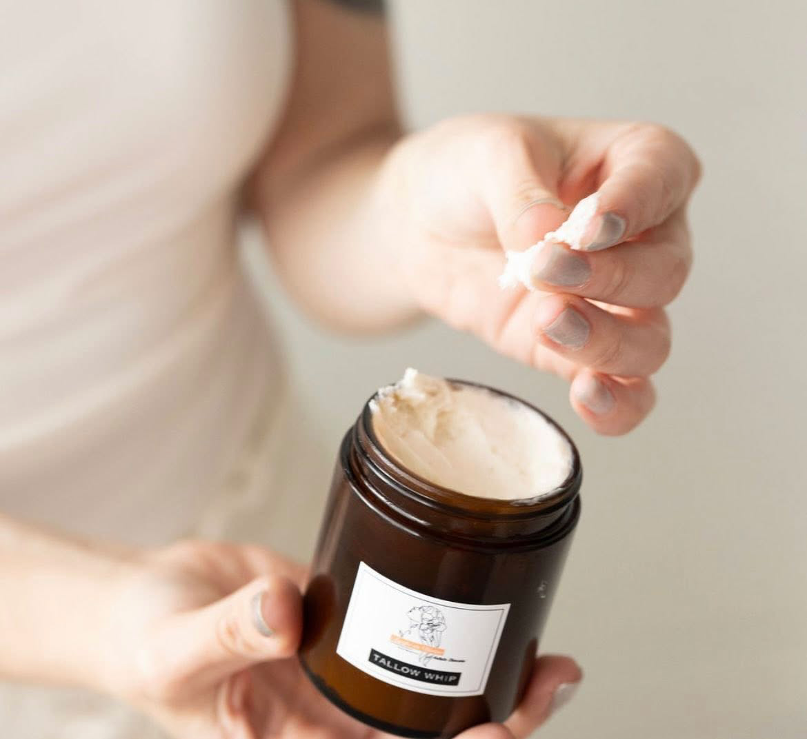 Hand holding tallow whip to show consistency. 