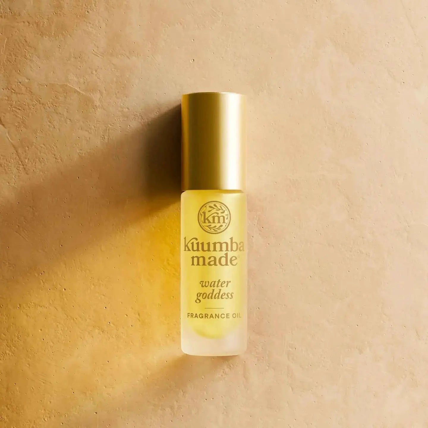 Fragrance oil bottle labeled 'kumbamade water goddess' on a beige background