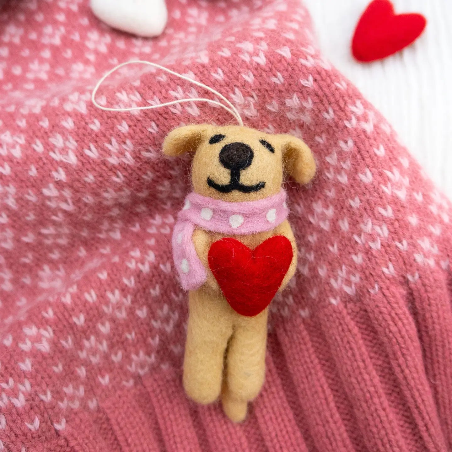 Small felt dog with a red heart and pink scarf.