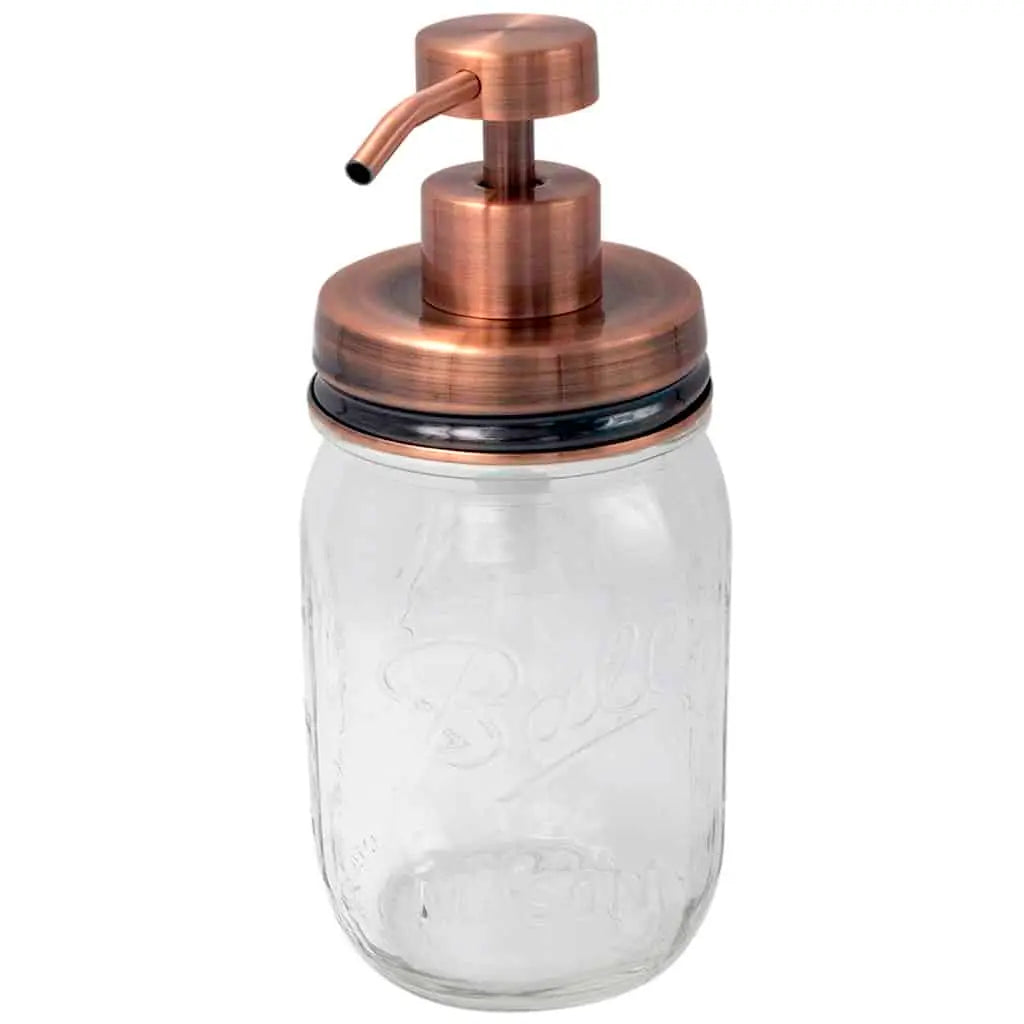 Clear glass jar with copper pump lid on a white background