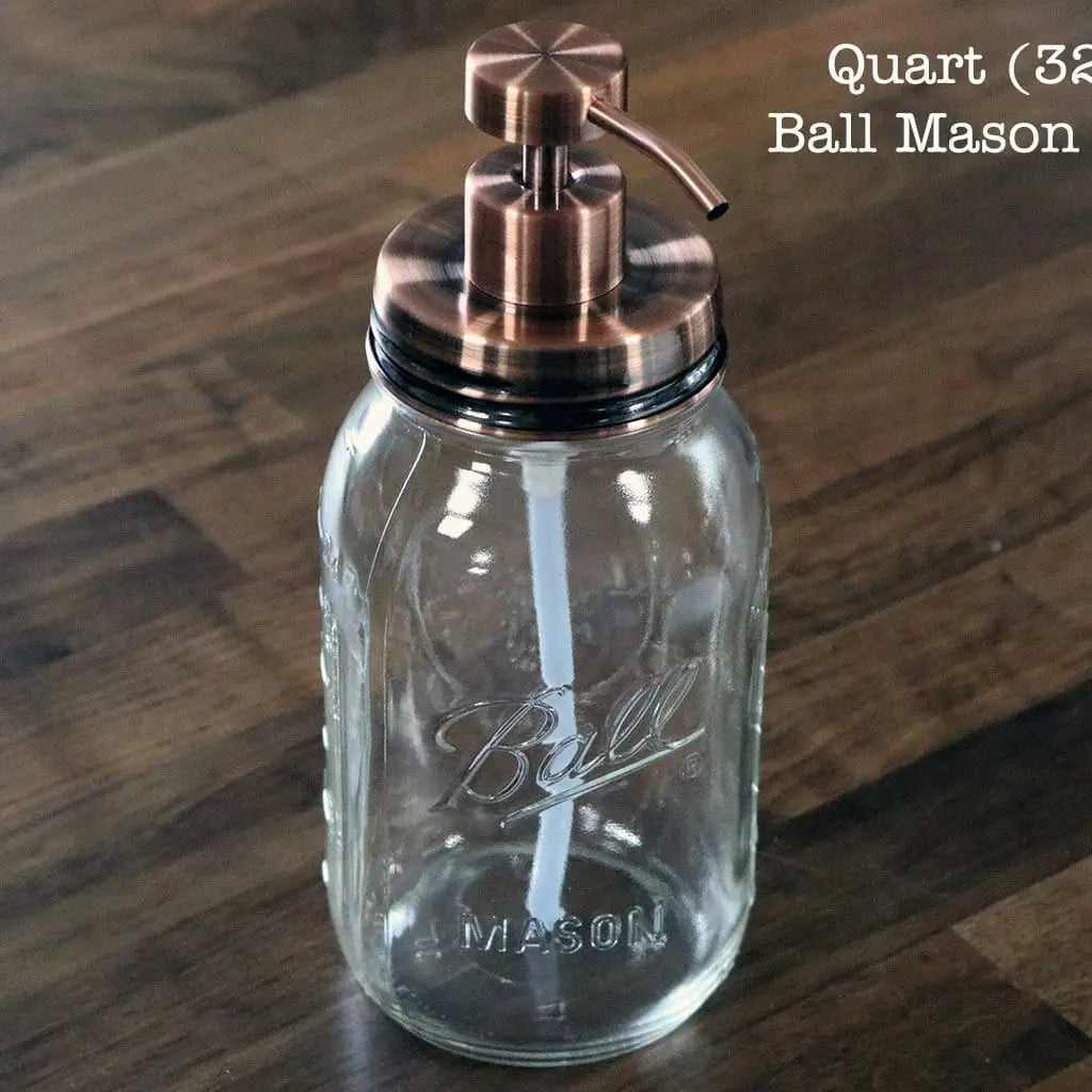 Glass quart mason jar with copper pump lid on a wooden surface