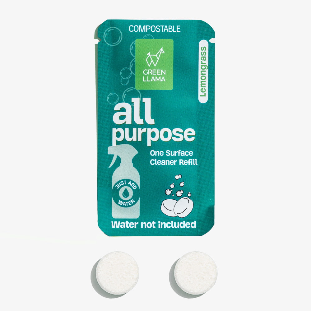 Green refill packet for all-purpose cleaner with two white tablets on a white background